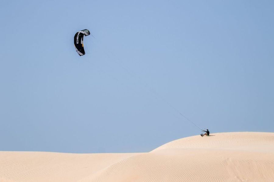Parasailing over Desert Dunes